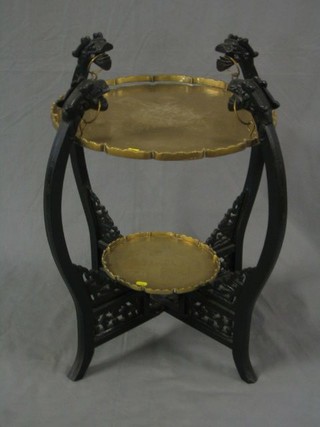 An Eastern engraved brass and ebony 2 tier occasional table, raised on a stand carved dragons 19"