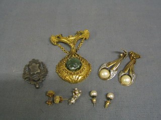 A silver watch chain medallion, 2 pairs of ear studs, a "silver" charm in the form of a teddybear, a pair of earrings and a brooch