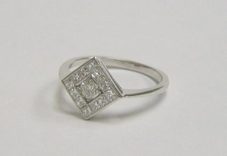 A lady's 18ct white gold dress ring set a diamond surrounded by 11 further diamonds (approx 0.60ct)