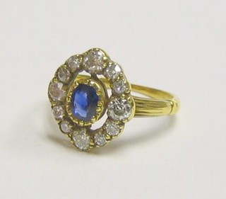 A lady's 18ct yellow gold dress ring set an oval cut sapphire surrounded by 12 diamonds (approx 0.64ct)
