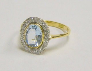 A lady's 18ct yellow gold dress ring set an oval cut aquamarine surrounded by numerous diamonds