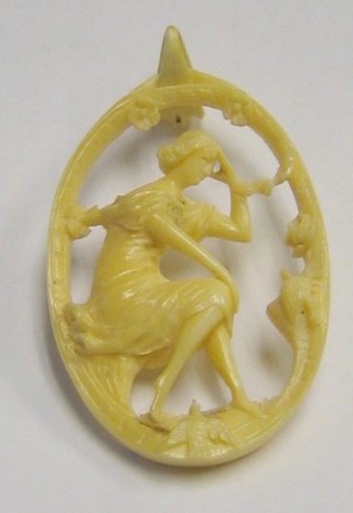 An oval pierced ivory pendant in the form of a lady with bird 3"