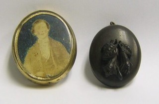 An early "plastic" oval photo locket, the lid carved flowers and a double sided photo locket