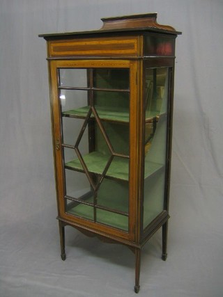 An Edwardian inlaid mahogany display cabinet, fitted adjustable shelves, enclosed by an astragal glazed panelled door, raised on square tapering supports 24"