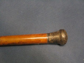 A Malacca walking cane with silver handle