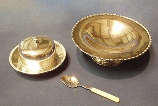 A circular silver plated butter dish and cover, 2 brass thistle spirit measures, a jam spoon and a circular silver plated bowl, raised on a spreading foot