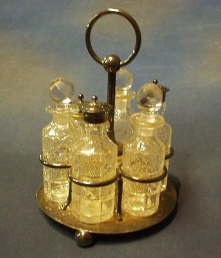 A 19th Century 6 bottle cruet set with cut glass bottles, raised on a circular silver base