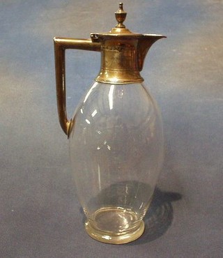 A Victorian plain glass claret jug with silver mount London 1882