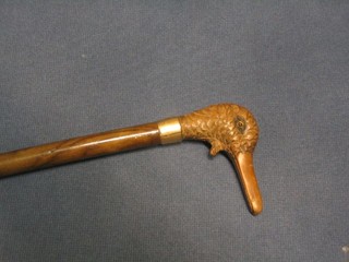 An Edwardian lady's parasol the carved wooden handle in the form of a ducks head with articulated mouth