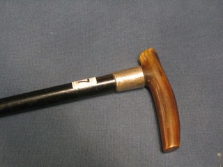 A 19th Century ebony walking stick with silver band and horn handle
