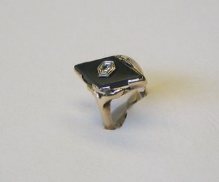 A gold mourning ring set a diamond shaped black stone, set a diamond