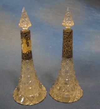 A pair of cut glass perfume bottles with embossed silver banding  9" (1f)