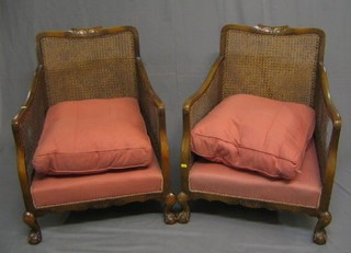 A 1930's 3 piece bergere suite with 2 seat settee and 2 matching armchairs with single cane panels and upholstered in pink material, on cabriole supports