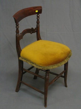 A Victorian simulated mahogany bar back bedroom chair with carved mid rail and upholstered seat, on turned supports