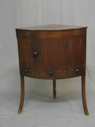 A 19th Century mahogany enclosed corner wash stand, enclosed by a panelled door and with hinged rising lid, the base fitted a drawer and raised on outswept supports 25"