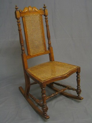 A Victorian bleached walnutwood nursing chair with woven cane seat and back, raised on turned and block supports 30" 