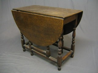 An 18th/19th Century oak oval drop flap gateleg dining table, raised on turned and block supports 36"