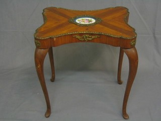 A 19th Century French Kingwood butterfly shaped  occasional table, the centre with "Sevres" porcelain plaque and gilt metal mounts, 21", raised on cabriole supports