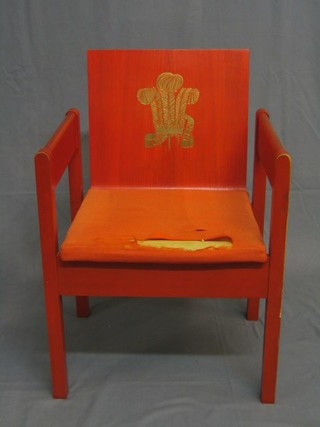 A red plywood painted open arm chair, used at the Investiture of The Prince of Wales at Caernarvon Castle 1969 (NB designed by Lord Snowden)