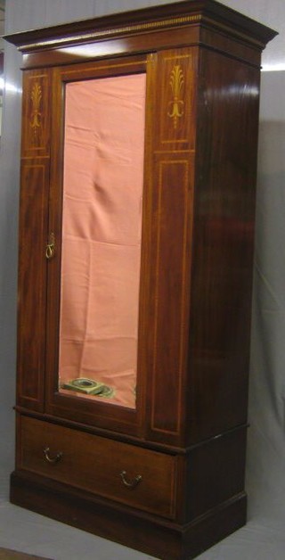 An Edwardian inlaid mahogany single wardrobe enclosed by a panelled door, the base fitted a drawer, 42"