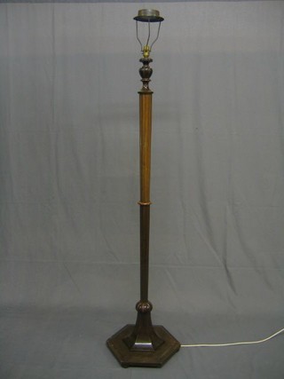 A turned and fluted mahogany standard lamp, raised on an octagonal base
