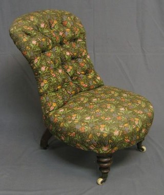 A Victorian mahogany framed nursing chair upholstered floral buttoned material, on turned supports ending in ceramic castors