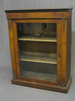 A Victorian walnutwood Pier cabinet with gilt metal mounts, the interior fitted adjustable shelves  and enclosed by glazed panelled doors, raised on a platform base 30"