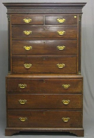 A handsome Georgian red walnut secretaire chest on chest the upper section with moulded cornice and blind fret work frieze, supported by 2 reeded columns with brass caps, fitted 2 short and 2 long drawers above a secretaire drawer, the base fitted 3 long drawers, raised on bracket feet 42"