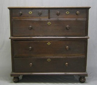 A 17th/18th Century Continental oak chest of 2 short and 3 long drawers with tore handles raised on bun feet (in 2 sections)