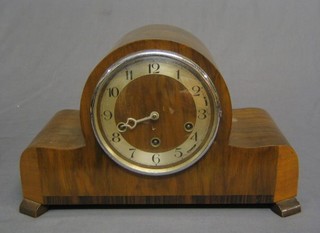A 1930's Art Deco 8 day chiming mantel clock with Arabic numerals contained in a walnut Admiral's hat shaped case