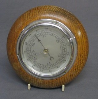 A 1950's aneroid barometer with silvered dial contained in an oak socle case 4"