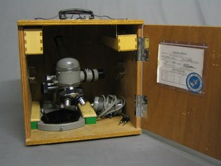 An Olympus electric microscope, boxed and complete with inspection certificate, serial no. 201595, dated 11 September 1969