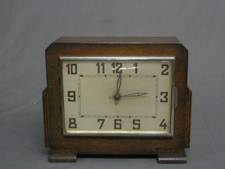 A 1930's Bulle Windsor model electric mantel clock contained in  a square oak case with silvered dial