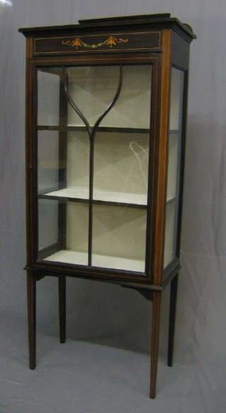 An Edwardian inlaid mahogany display cabinet, the interior fitted adjustable shelves enclosed by astragal glazed panelled doors and raised on square turned supports 24"