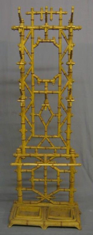 A 19th Century bamboo effect cast iron umbrella stand, the reverse marked B72R, complete with drip trays