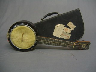 A Kech Banjulele 4 string banjo complete with carrying case