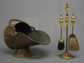 A copper helmet shaped coal scuttle (f), together with brass fireside companion set