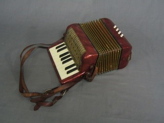 A childs Honer accordion with 8 buttons 
