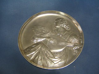 An Art Nouveau circular embossed pewter dish decorated an Angel playing a mandolin, the reverse marked 306A 9 1/2"