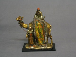 A 1930's Art Deco cold painted bronze cigarette lighter in the form of a carpet seller, raised upon a camel with attendant 8"