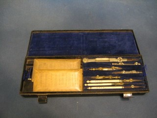 A 19th Century geometry set containing an ivory ruler and gauges etc contained in a black Japanned case