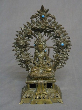 An Eastern pierced bronze figure of a Deity, raised on a pierced altar and with laurel garland 10"