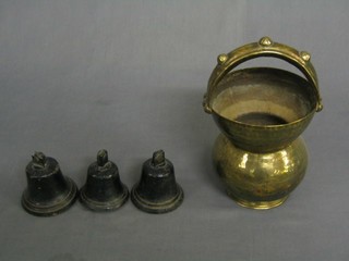 An Eastern engraved brass "spitoon" with carrying handle 7"  and 3 iron bells