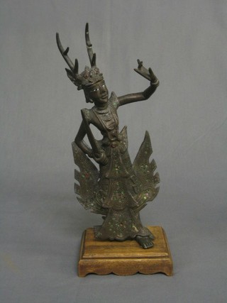 A modern bronze figure of an Eastern Deity raised on a wooden base 13"
