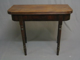 A 19th Century D shaped mahogany card table raised on turned supports 36"