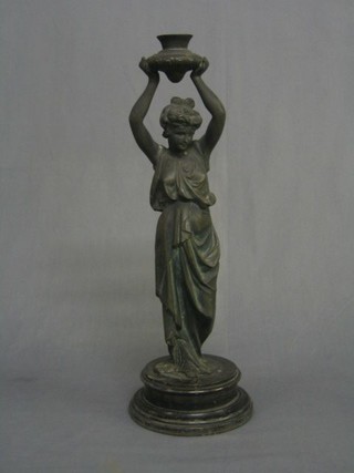 A 19th Century spelter candlestick in the form of a lady supporting an urn on head 16"