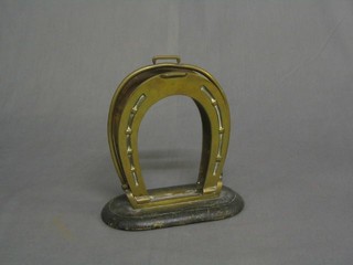 A brass letter rack in the form of a stirrup and 2 horse shoes 7"