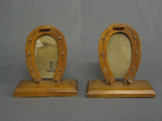 2 1930's carved oak picture frames in the form of horse shoes raised on square bases 8"