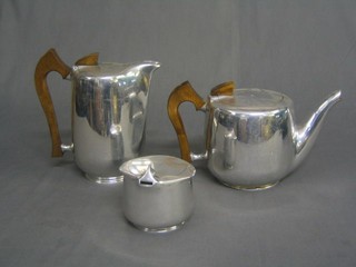 A 1950's Picquot ware 3 piece tea service comprising teapot, hot water jug and sugar bowl and a layered circular planished pewter 3 piece condiment set