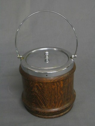 A 1930's oak turned biscuit barrel with chromium plated mounts